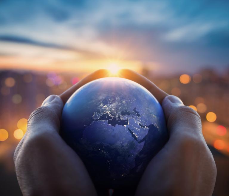 Globe in hands dusk